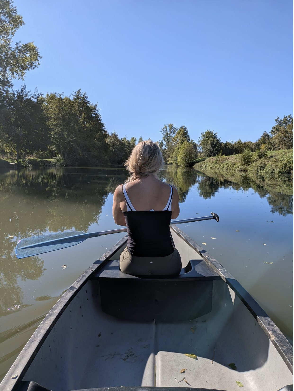 Canoeing peacefully along the emerald waters of the French Green Venice canals