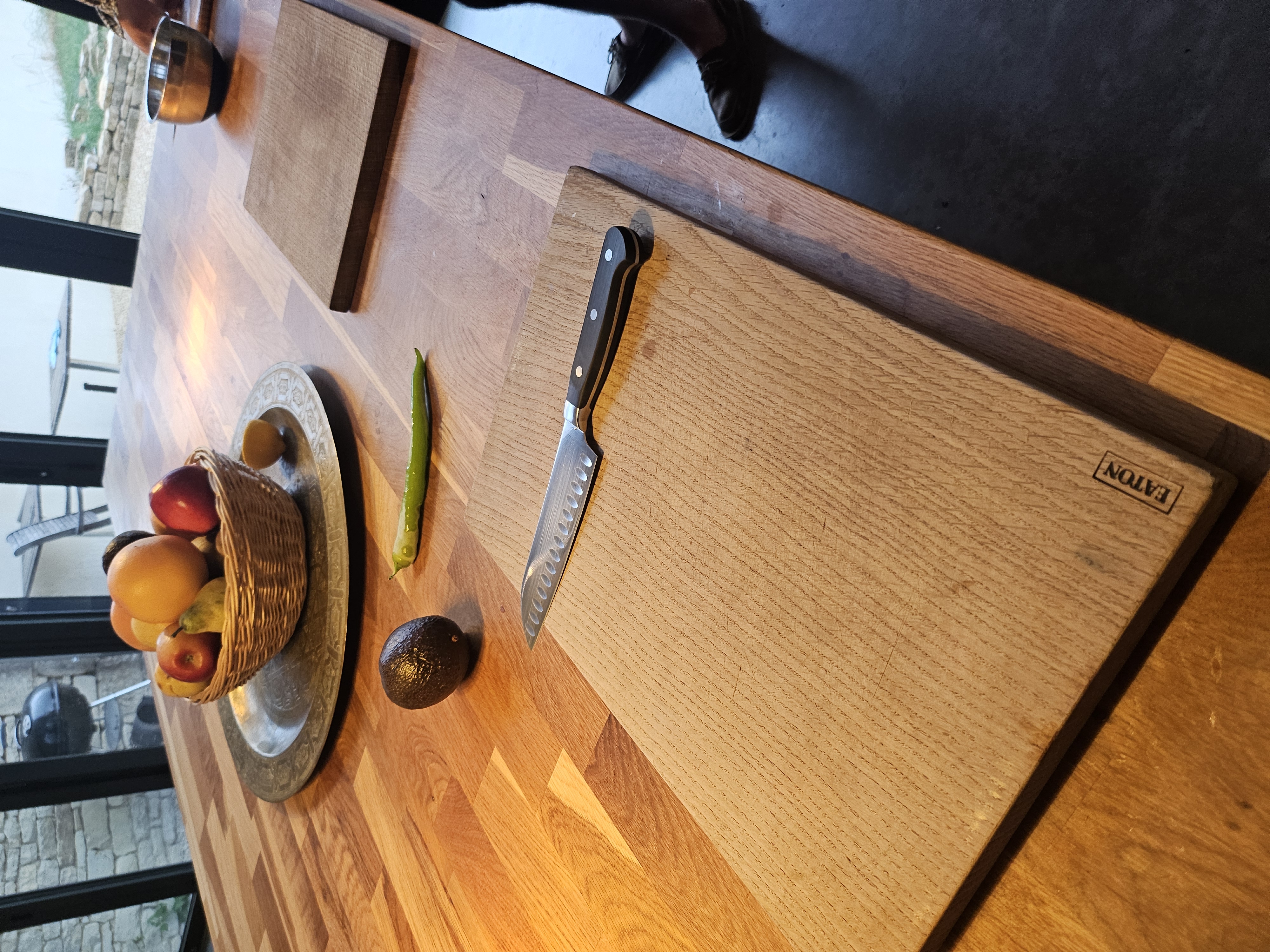 Chopping boards with fresh garlic, tomatoes, herbs, and ingredients for home-cooked dinner