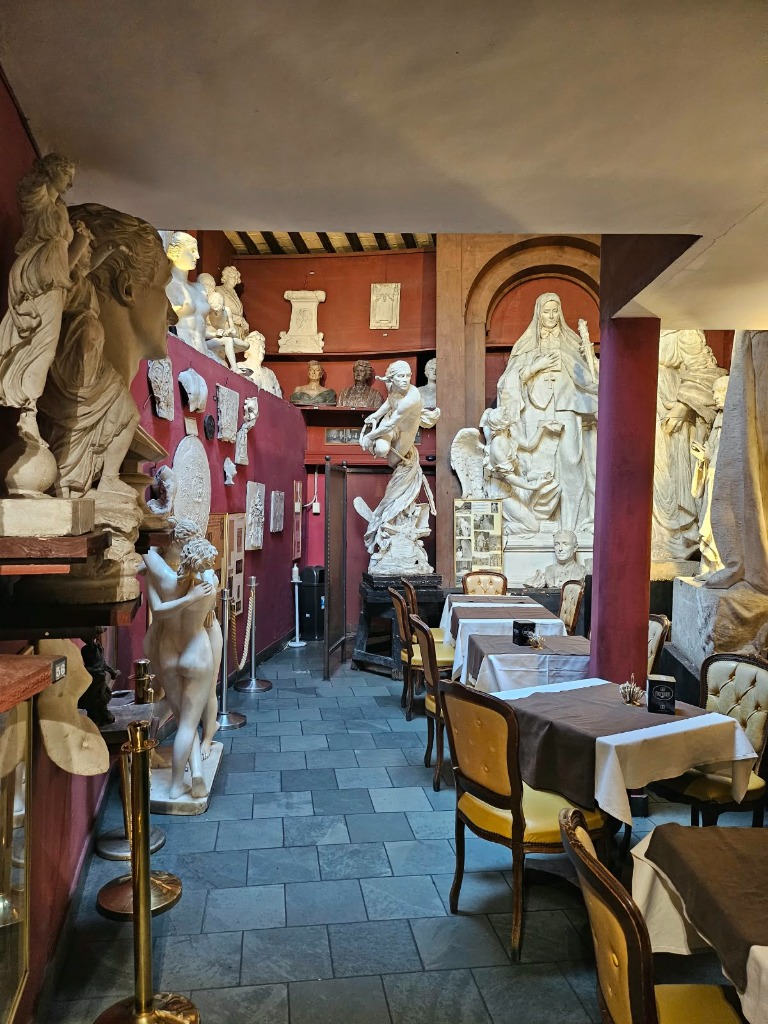 Interior of Caffe Canova Tadolini with 19th-century sculptures and cafe tables